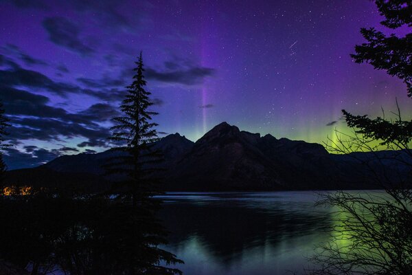 Northern lights at night on the background of mountains and lakes