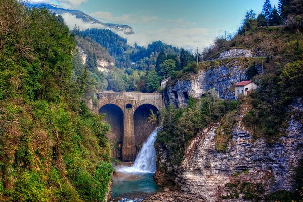 Natural landscape waterfall in the mountains around the forest