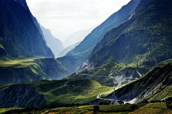 Eine gähnende Serpentine vor dem Hintergrund der grünen Landschaft von Tibet