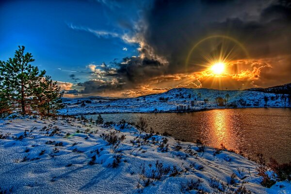 Winter landscape sunset by the river