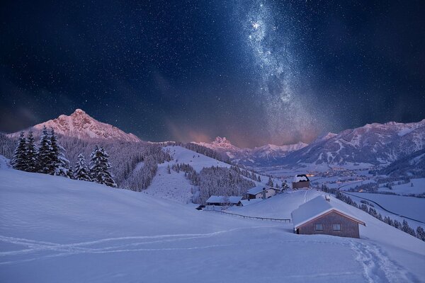 Starry night over snowy mountains