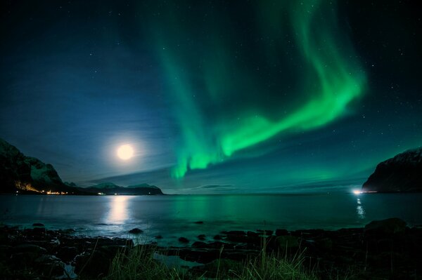 Aurora borealis over the bay on a moonlit night