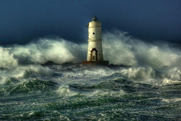 Lighthouse through the waves of the storm