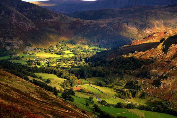 Autumn village with hill and trees in England