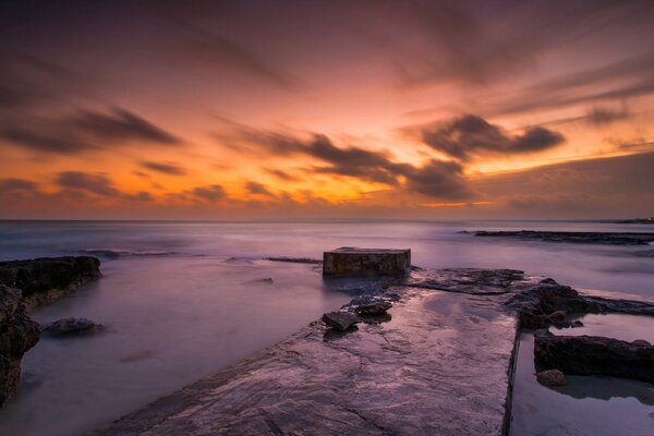 Clouds over the sea. Rocky shore