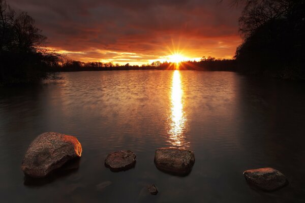 Morning sunrise over a lake with rocks