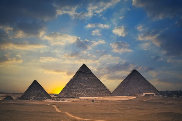 Desert, pyramids and sunset in the sky