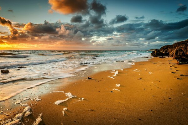 The deserted shore and the waves of the sea