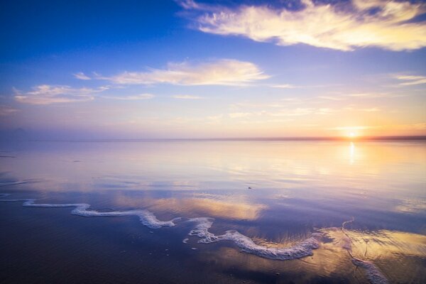 Playa de arena con sol naciente