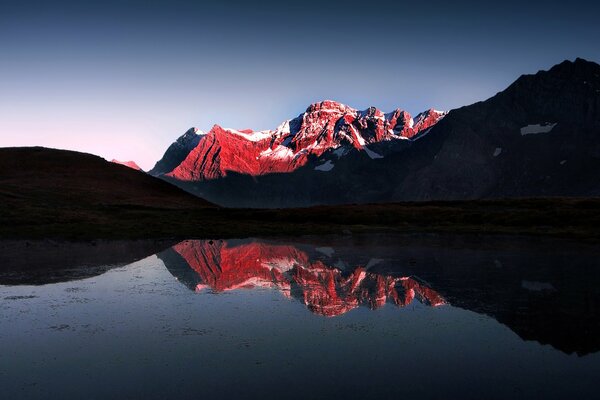 Light and darkness over the lake and mountains