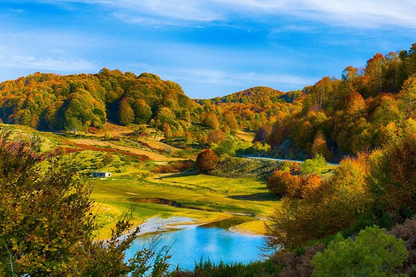 Autumn landscape depicting forests, hills and rivers