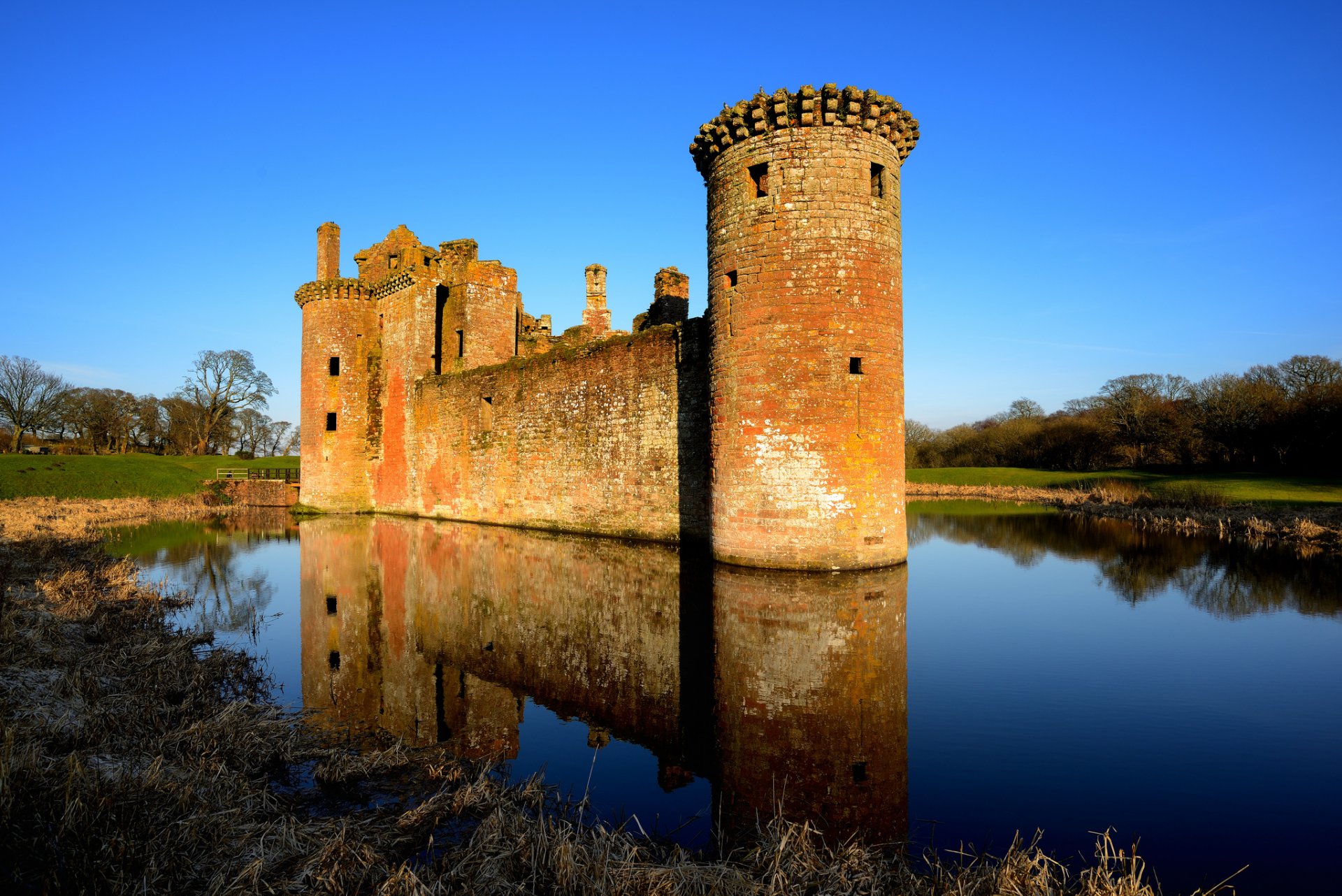 united kingdom scotland castle lake reflection tree forest field blue clear sky