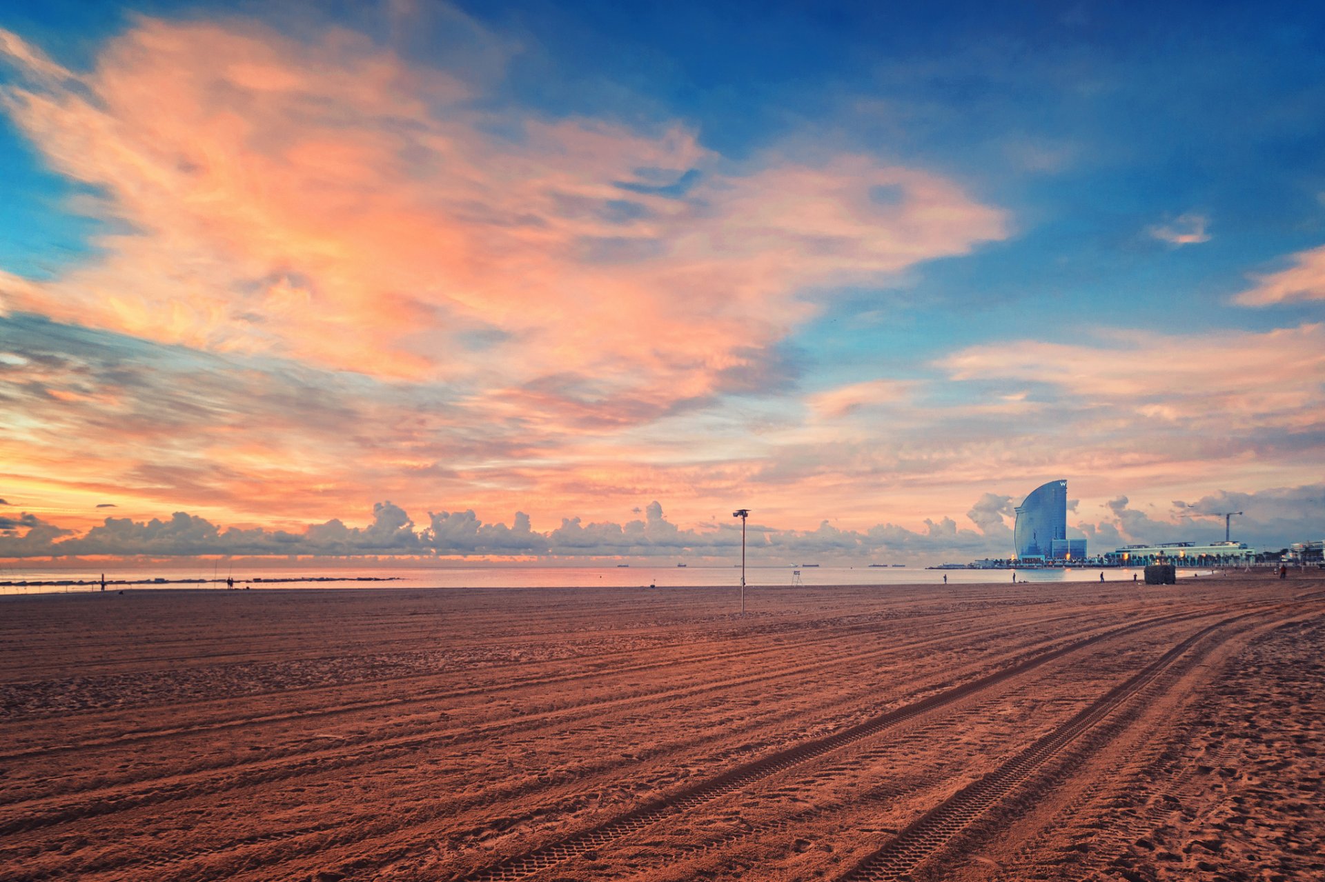 beach sand ocean sky water people house