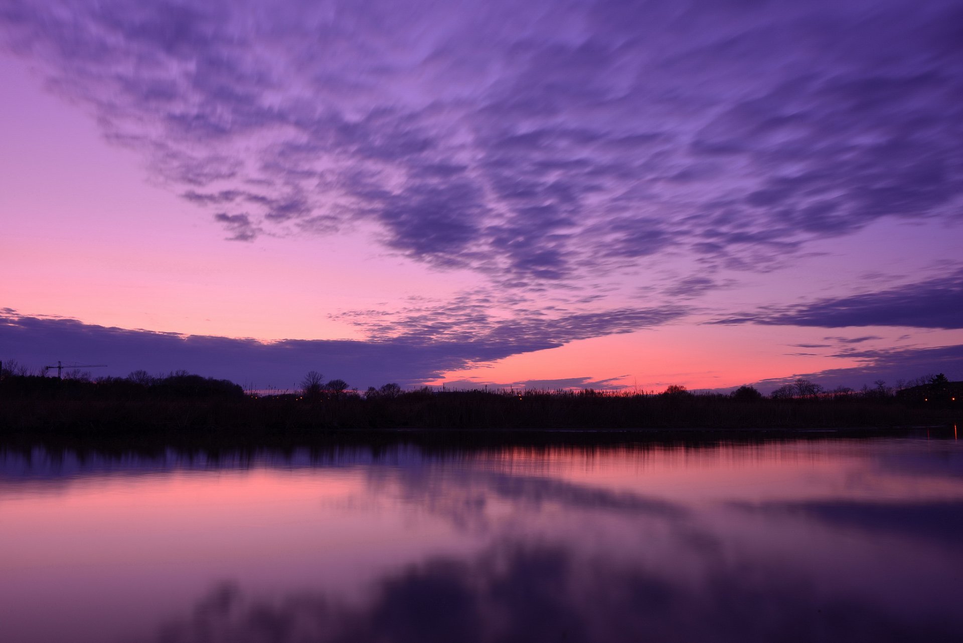 lago acqua superficie liscia alberi sera tramonto cremisi lilla cielo nuvole riflessione