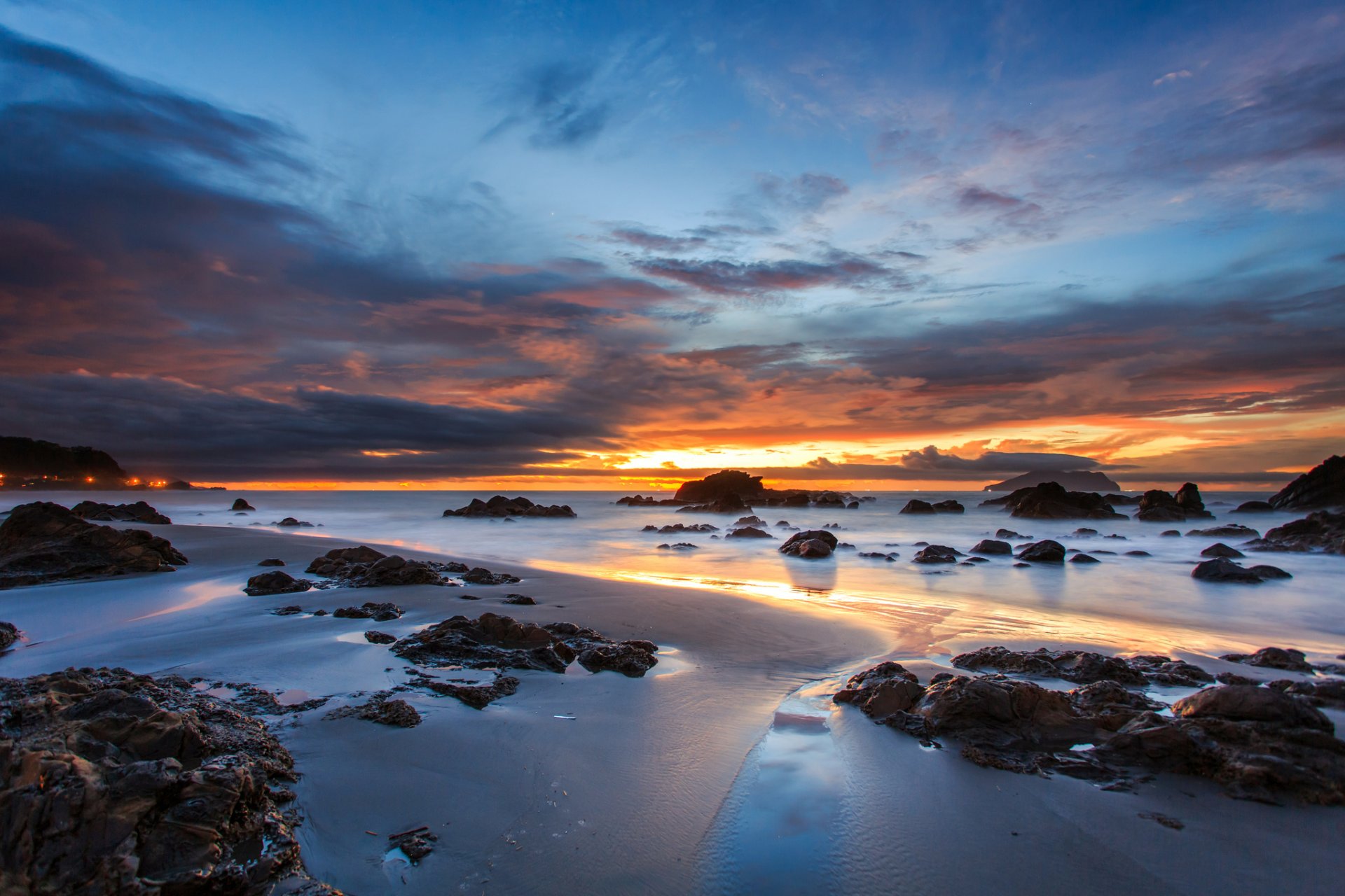 australia coast coast rocks sand ocean evening orange sunset blue sky clouds cloud