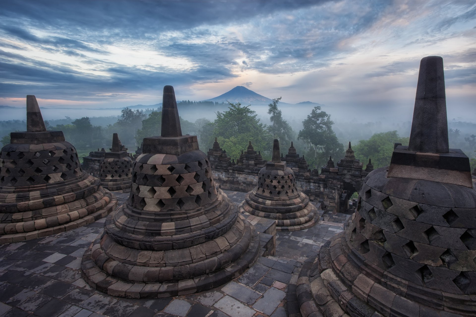 indonesia java borobudur architecture temple mountain tree fog haze night sky cloud