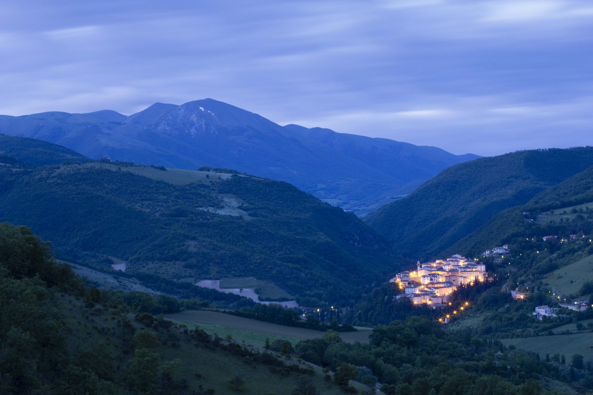 italy umbria village house lights lighting before dawn mountain tree nature panorama sky cloud