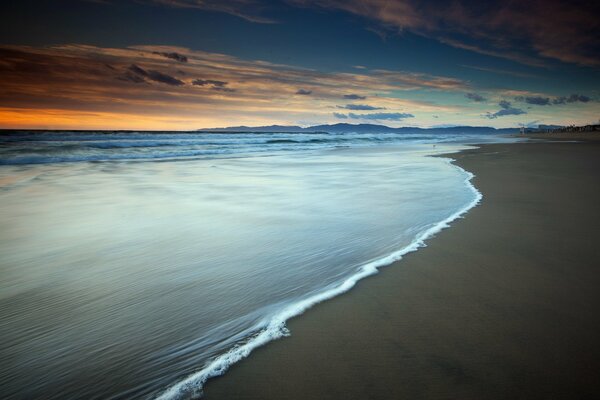 A wave runs up to the seashore