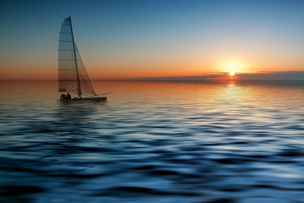 Yacht naviguant sur la mer au coucher du soleil