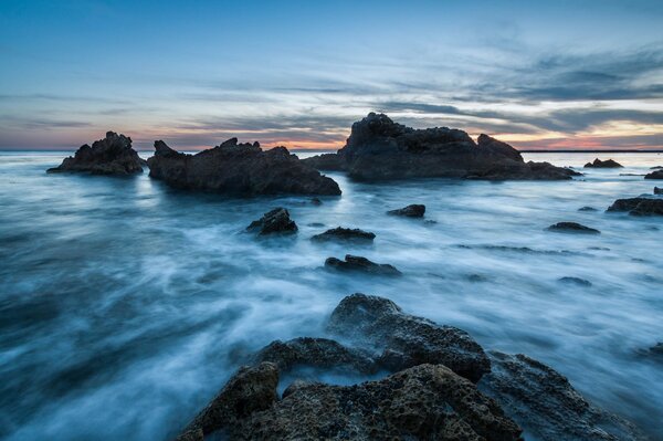 Rocks protrude from the water in the ocean