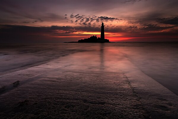 Lighthouse on the sea, against the night sky