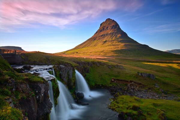 kirkjufellsfoss waterfall in Iceland on the background of a desert rocky landscape