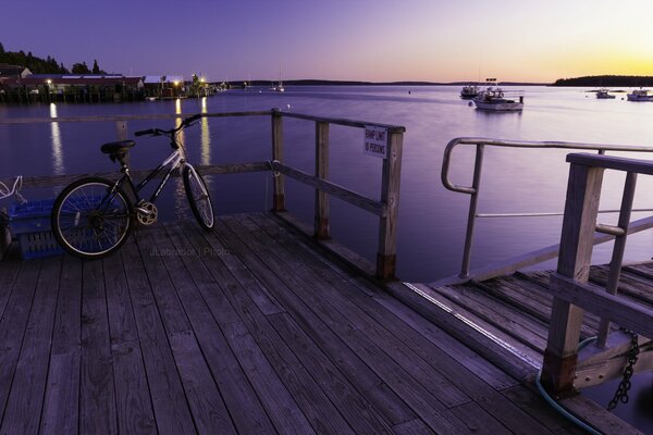 Lonely bike in the bay at sunset