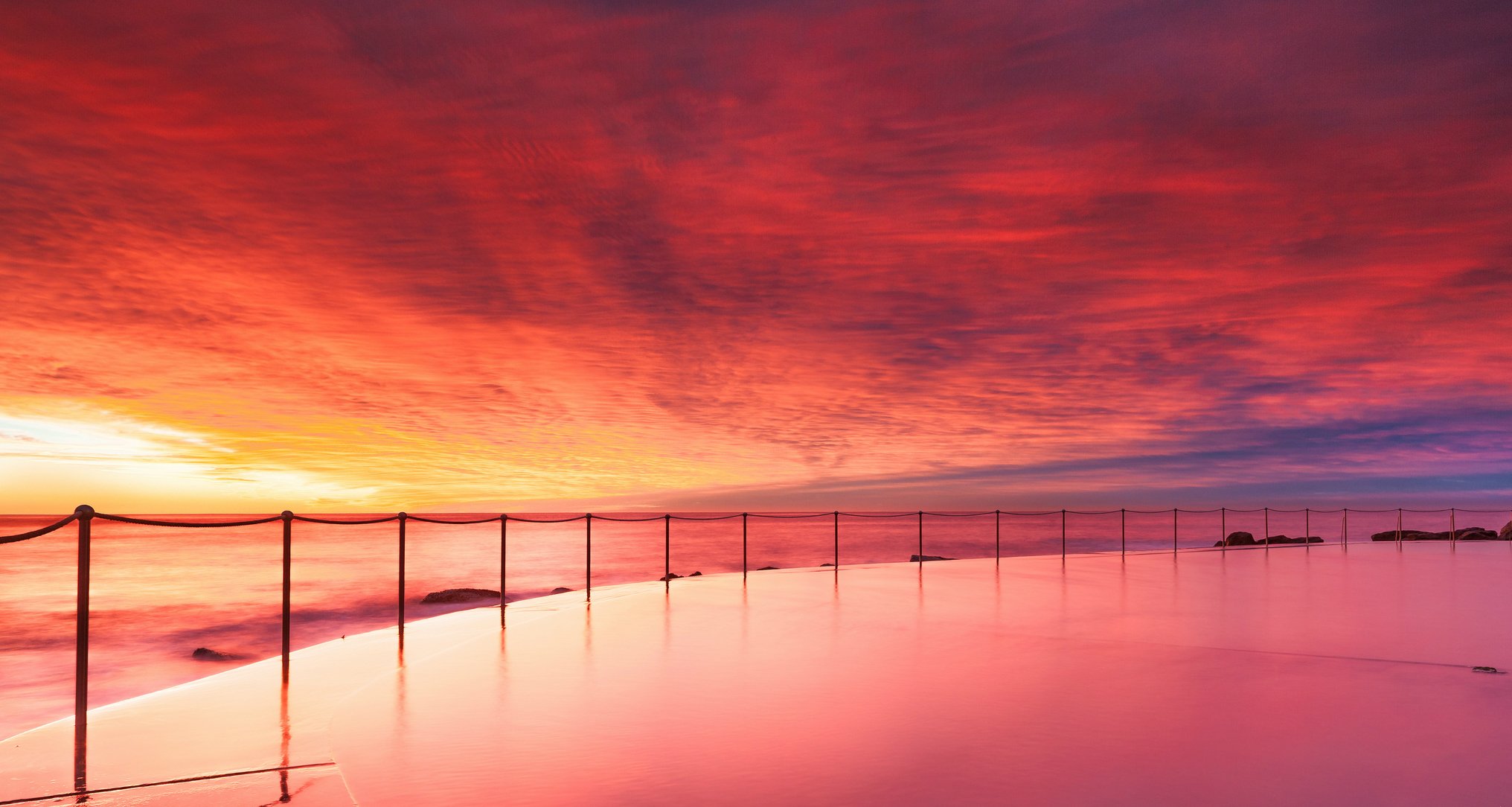 australia ocean shore pool beach fencing chains evening sunset sky cloud