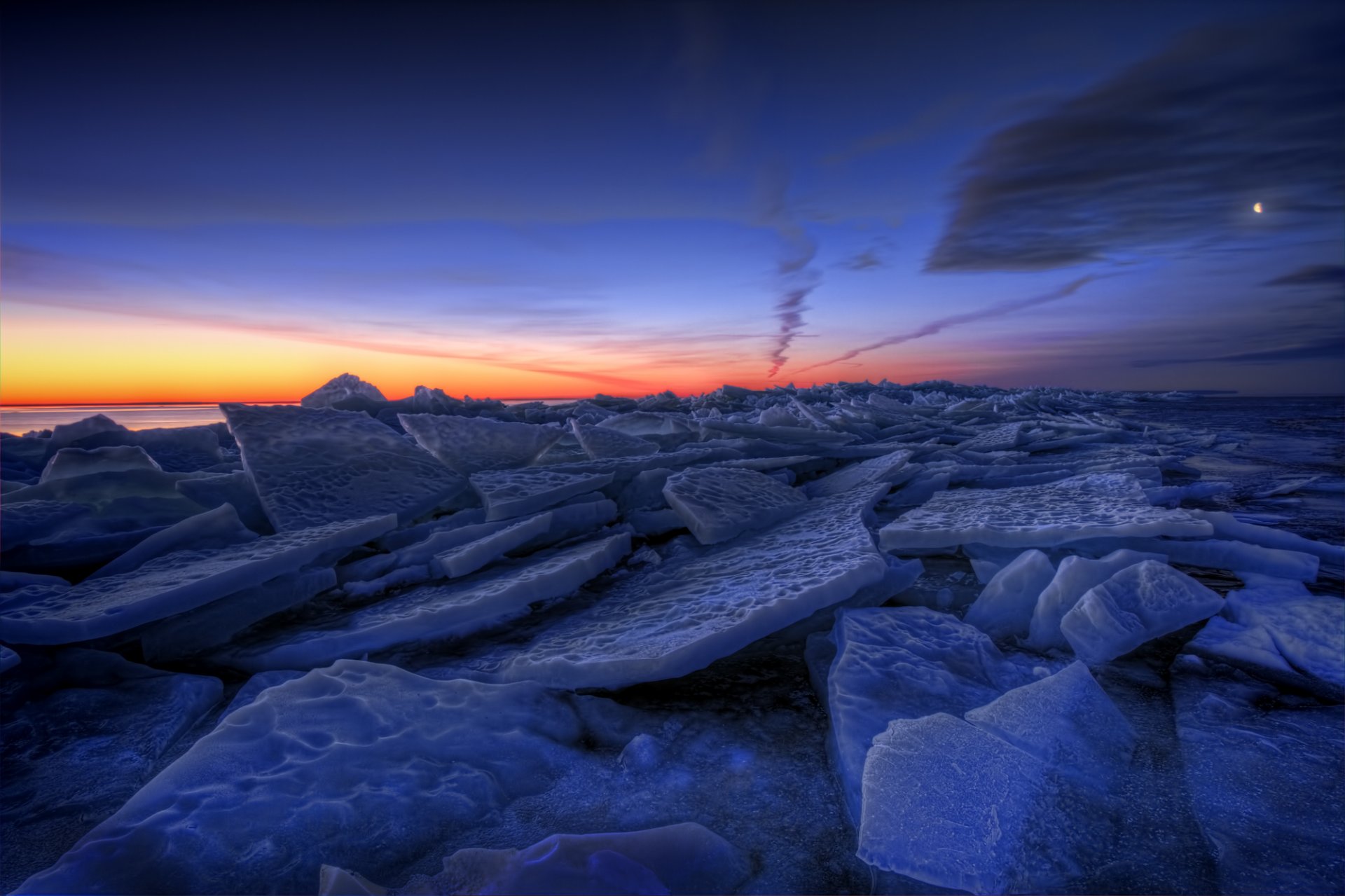 weden winter lake next ice floes night orange sunset blue sky clouds moon