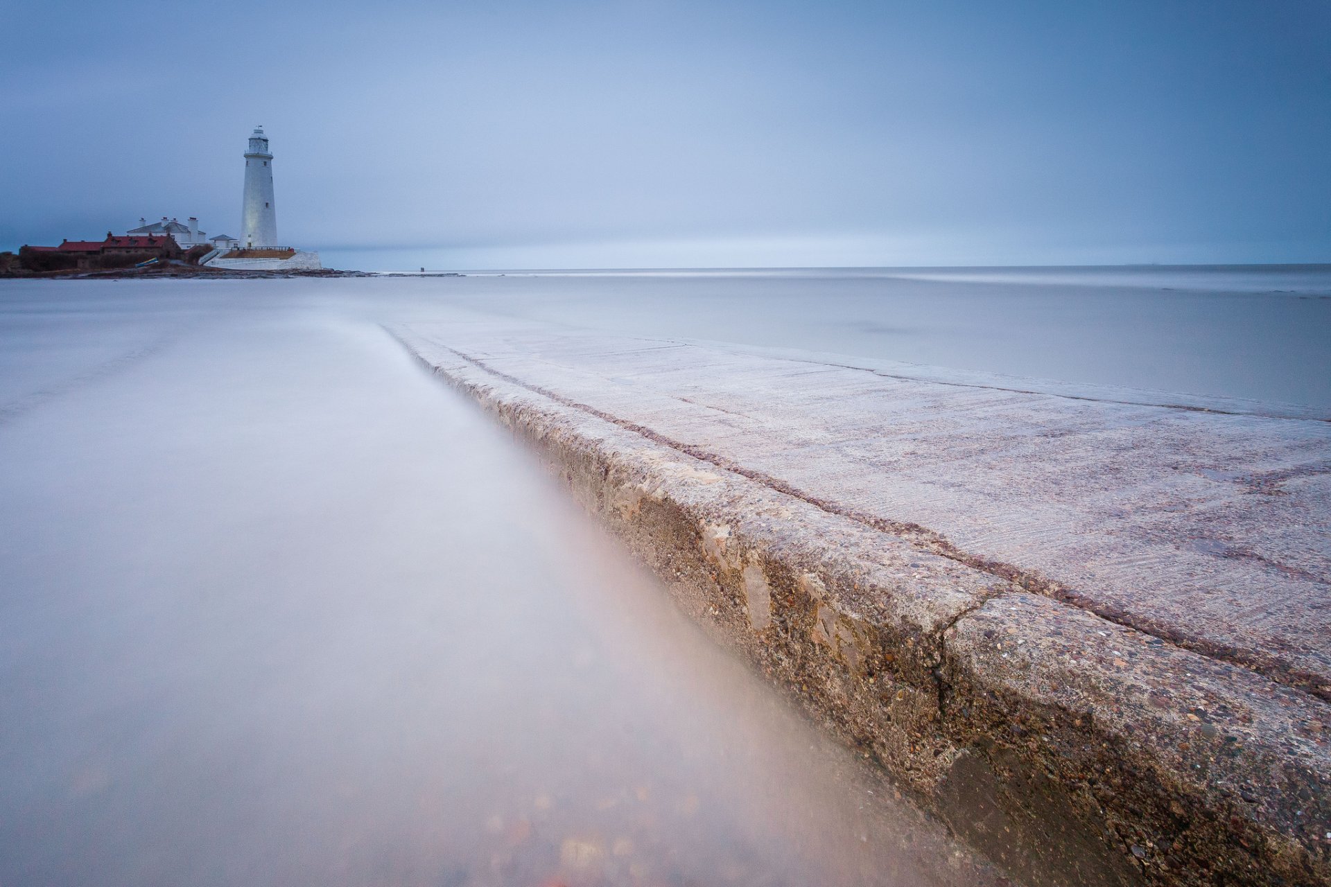 united kingdom england lighthouse sea beach calm blue sky