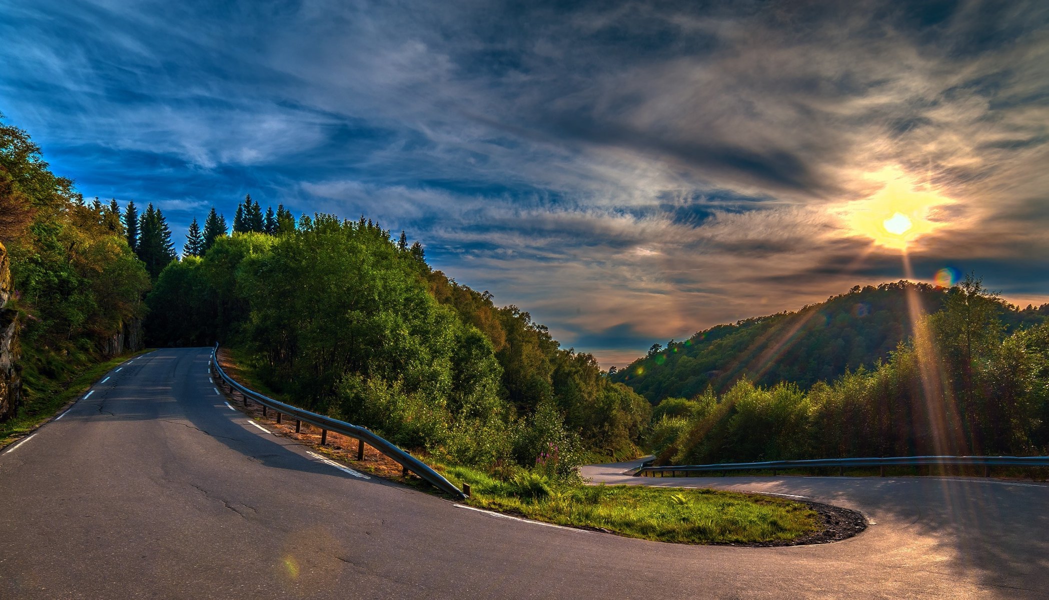 strada svolta asfalto colline foresta alberi tramonto nuvole