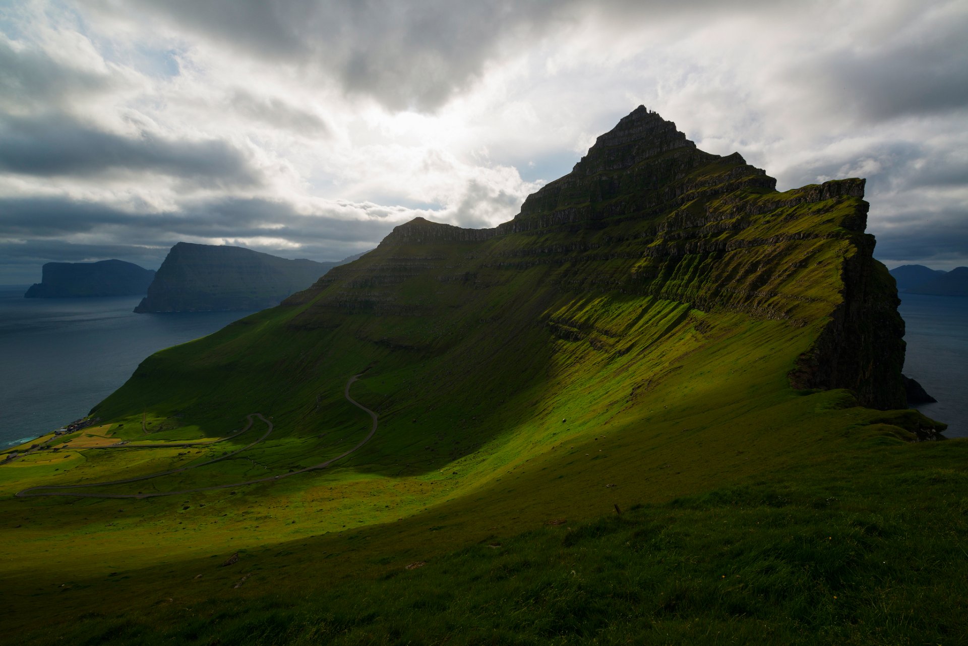 kingdom of denmark faroe islands atlantic ocean trollanes mountains slope greenery sky clouds cloud