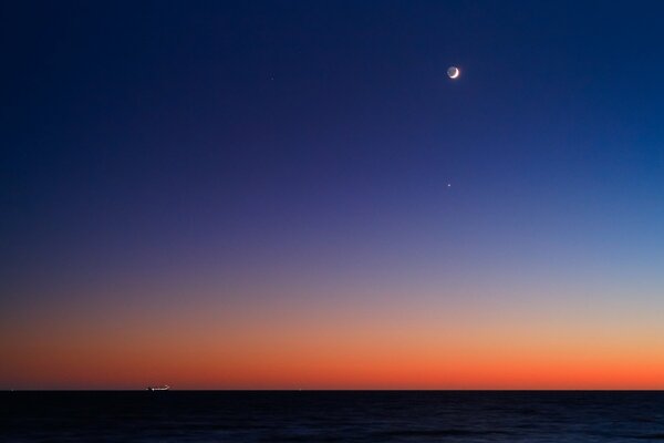 Horizon on the background of twilight and with the moon