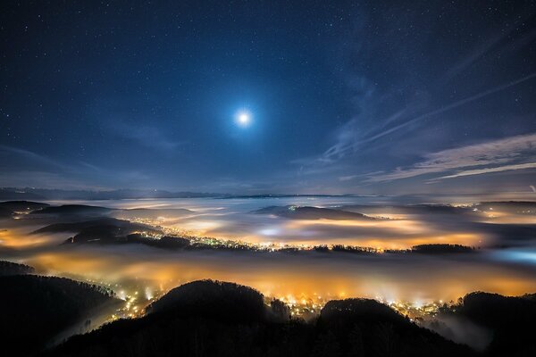 Stars above the hills of the misty city