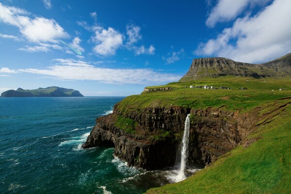 Faroe Islands, waterfall falls from a cliff