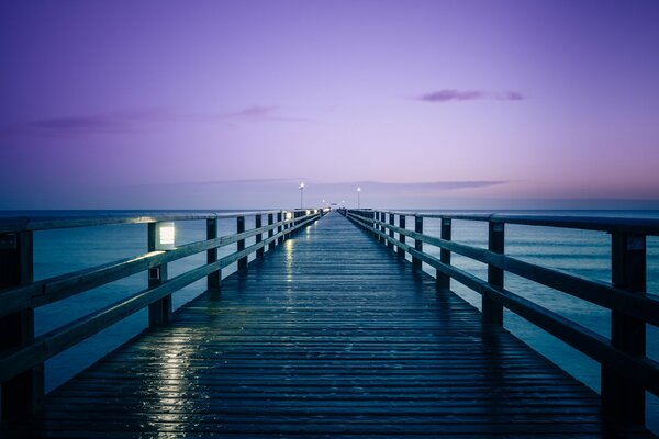 Pier on the sea in pink and blue tones