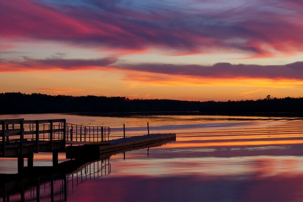 Orange sunset and the bridge by the lake