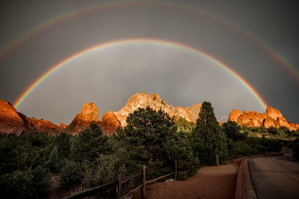 A rainbow stretches over the mountains