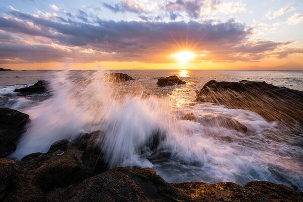 The stone coast and the splashes of waves