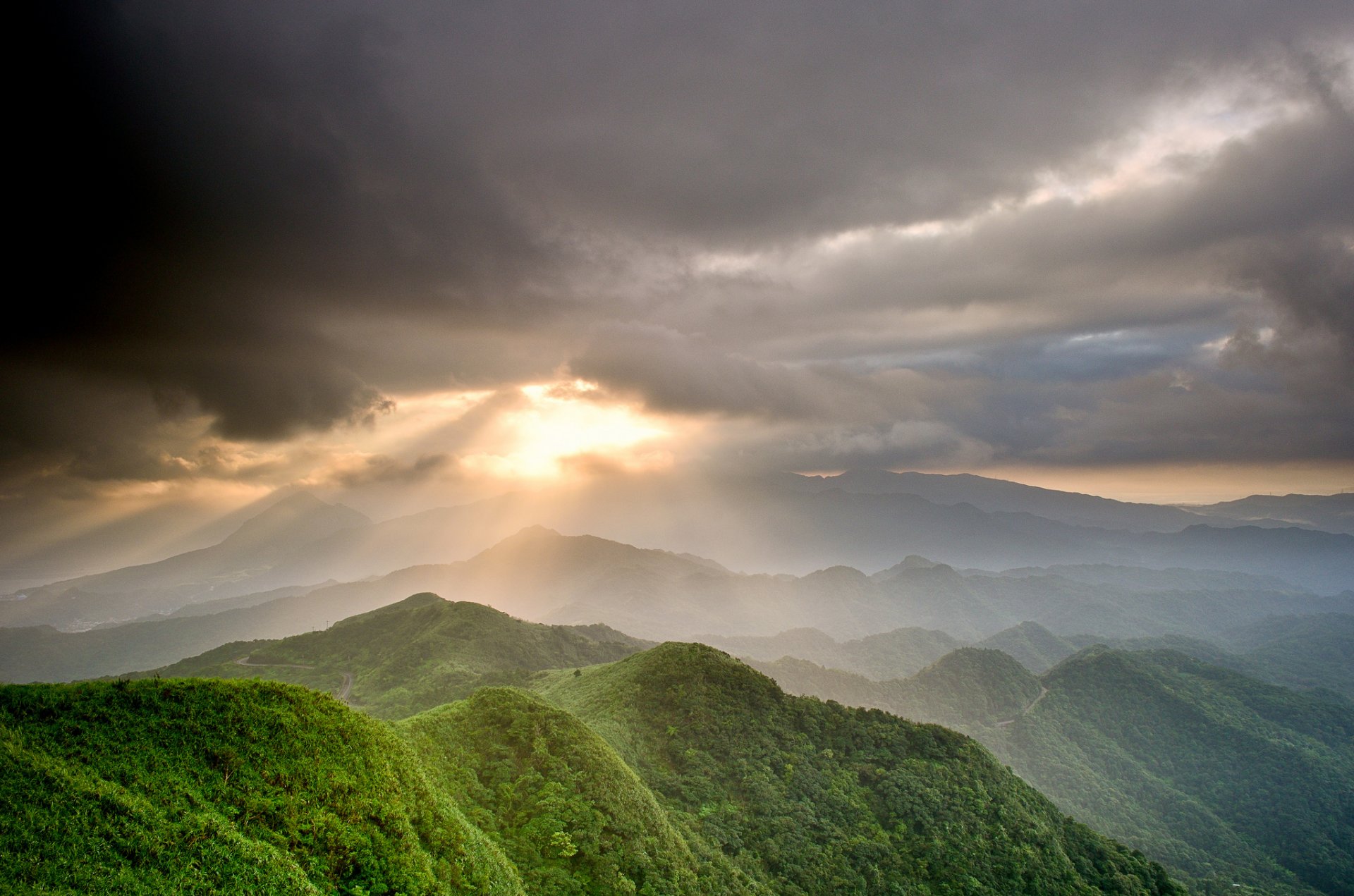 mountain sky clouds sun rays valley green