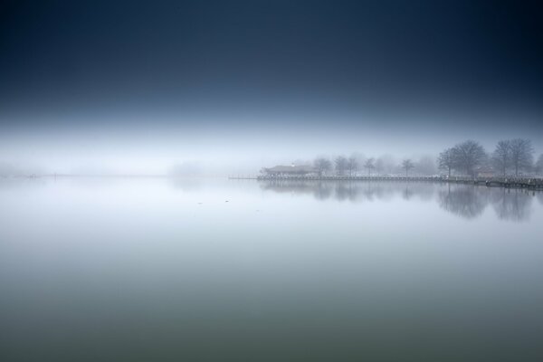 Foggy morning on the lake shore