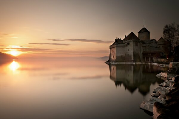 The ancient castle is reflected on the surface of the lake