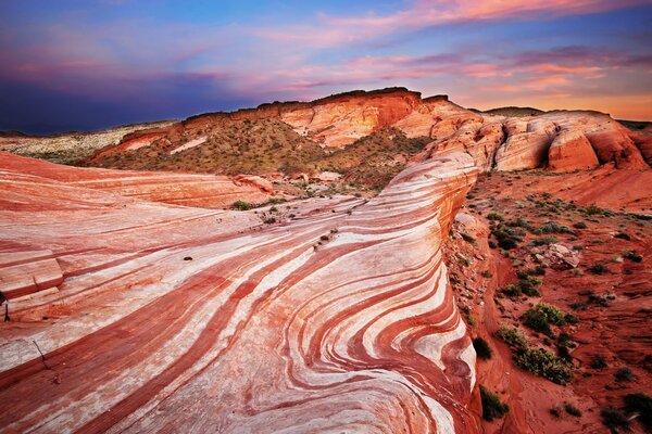 Sunset over the red rocky desert