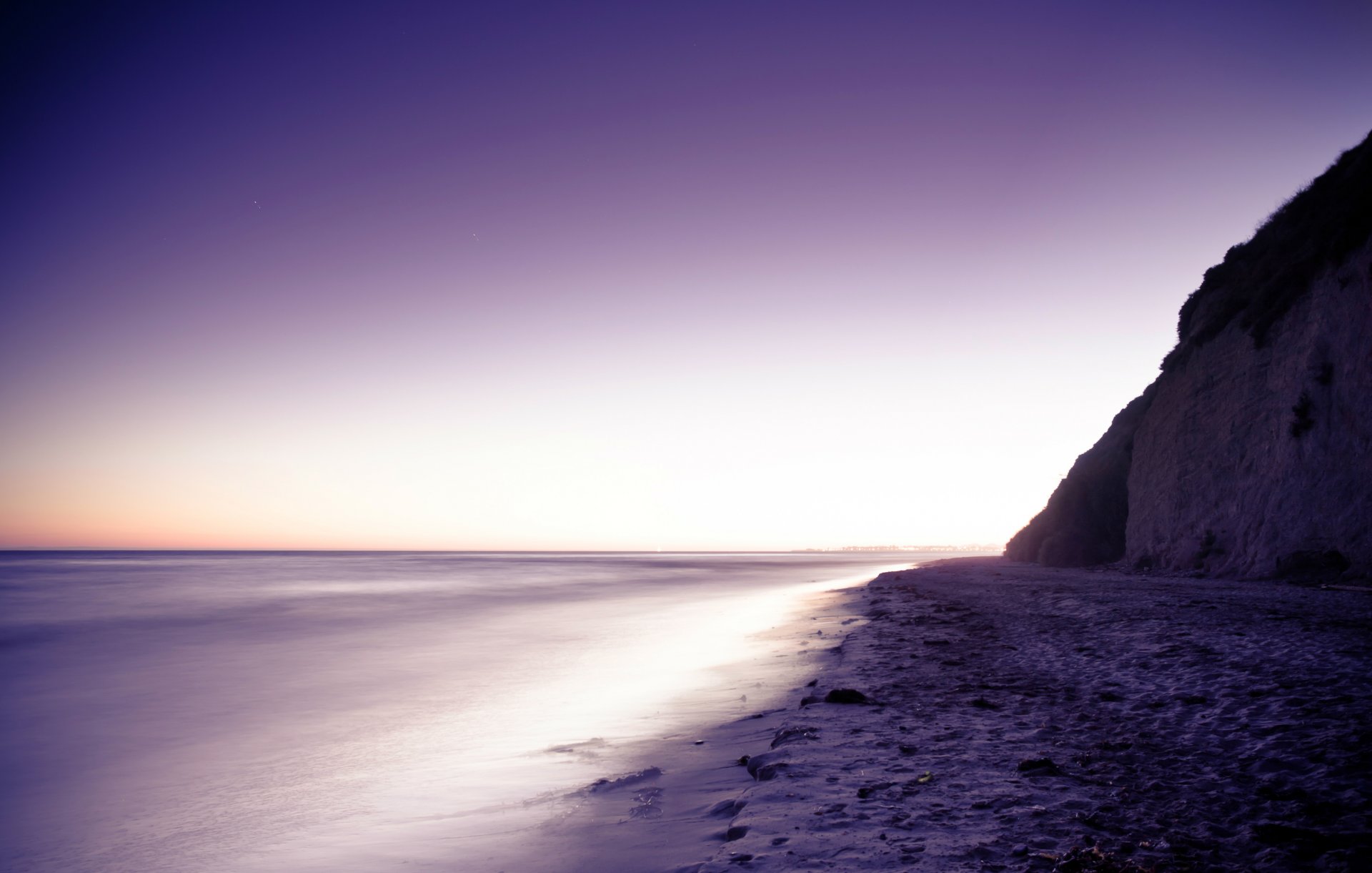 mountain beach stones sand sea purple evening