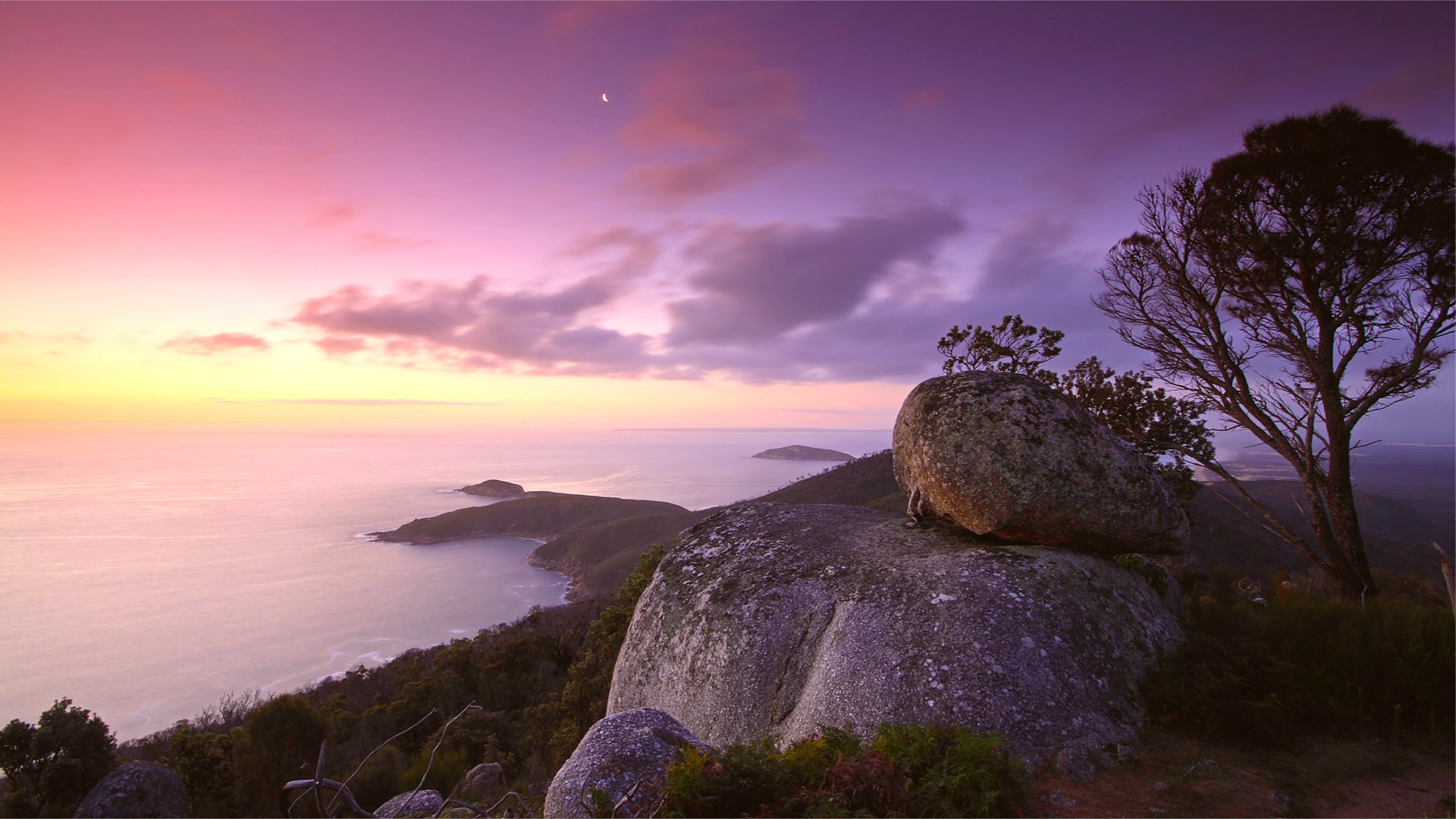 mare calma calma riva lilla sera rosa tramonto cielo nuvole collina pietre legno