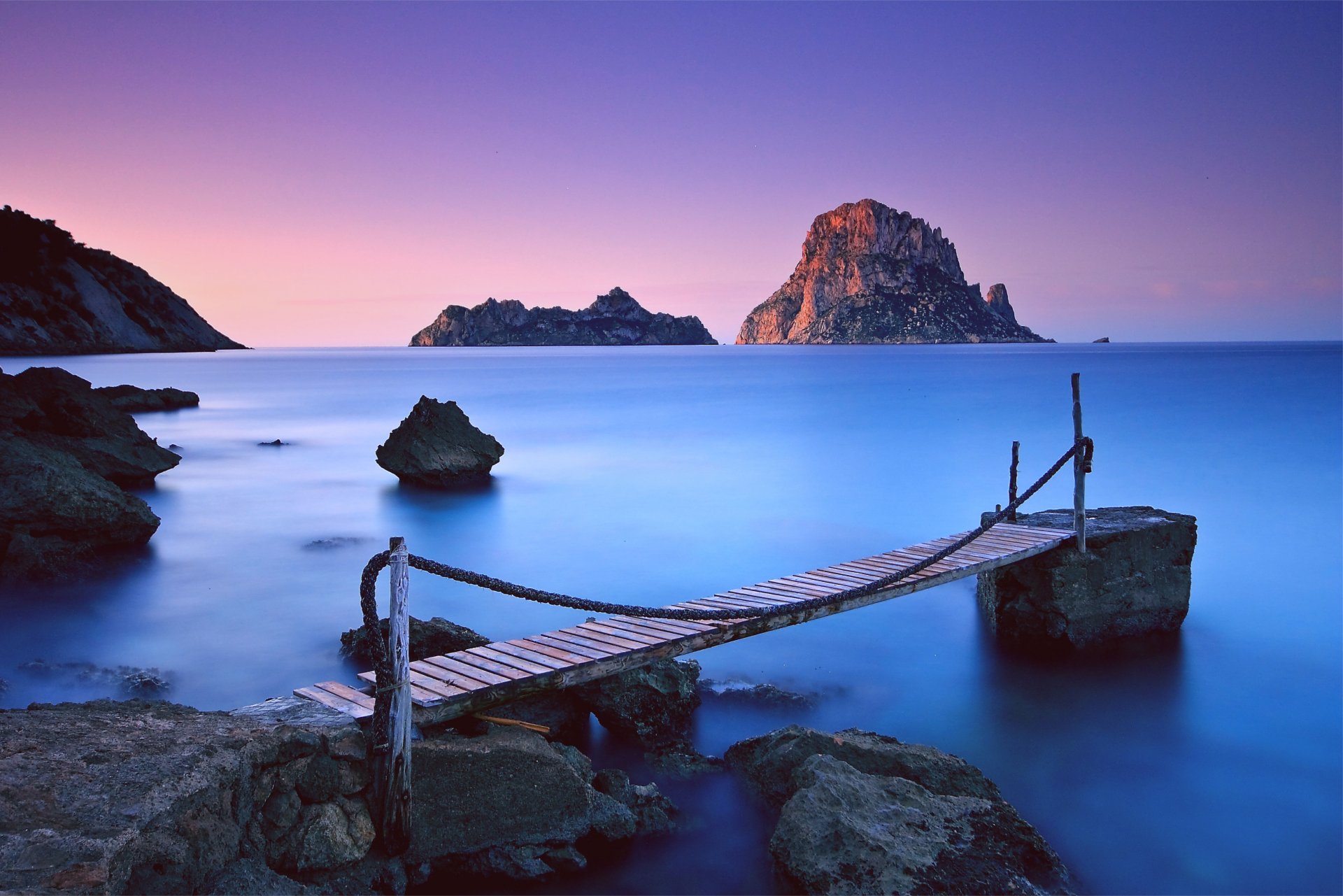 night pink sunset lilac sky mountain rock stones beach wood bridge chains sea ocean blue calm