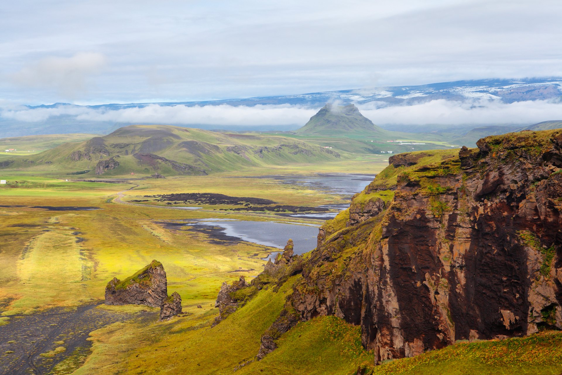 islande montagnes roches pentes herbe fleurs ciel nuages