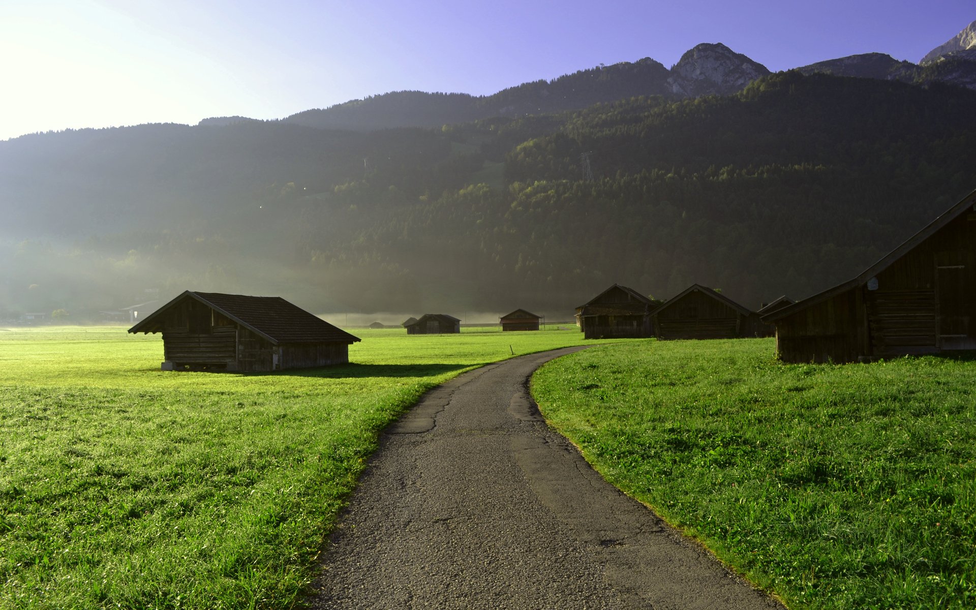 plain of the field track the way asphalt houses grass green morning dawn to start the day mountain hills forest tree sky view