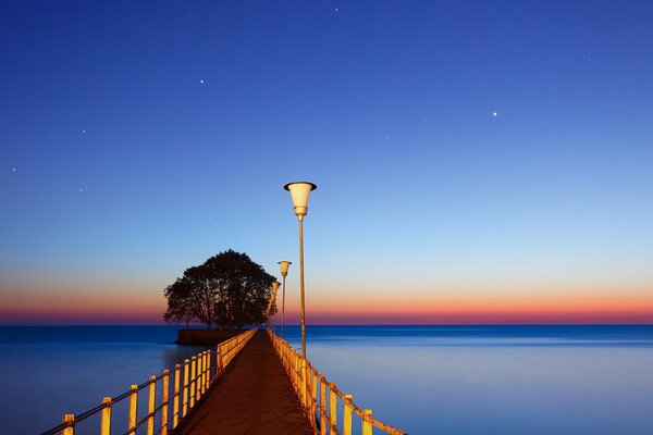 A bridge leading into the blue sea