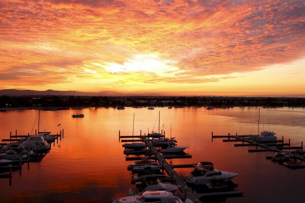 Sea sunset on the shore with yachts